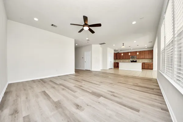 an empty room with windows and entrance