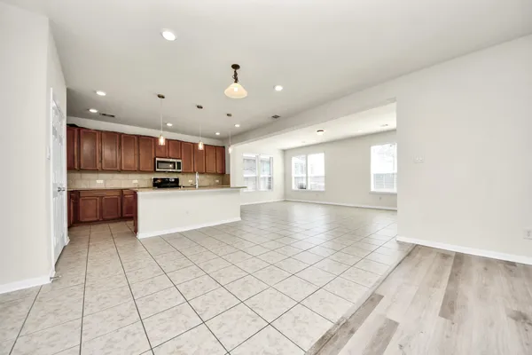 a view of a big room with closet and windows