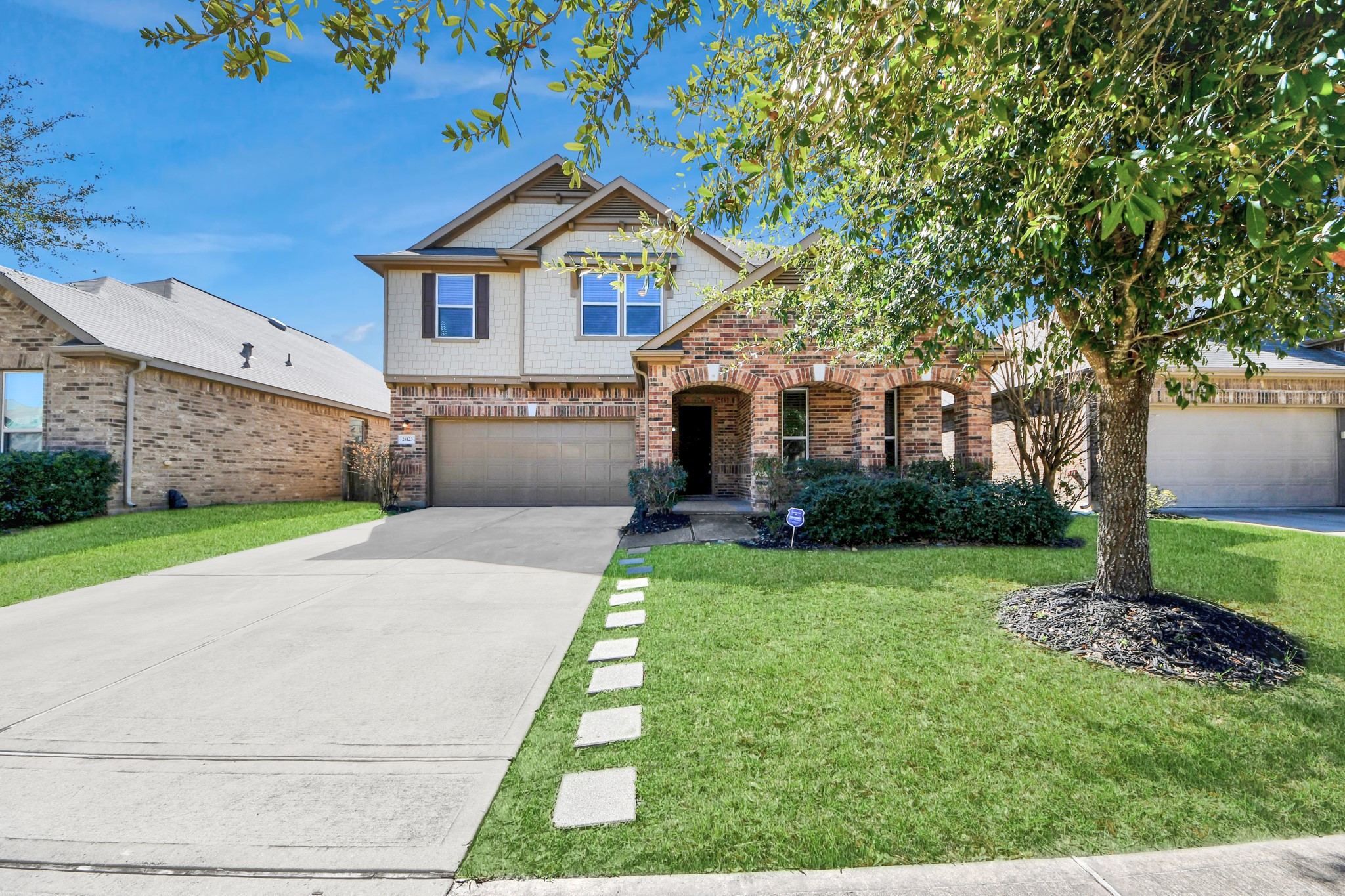24123 Adobe Ridge Lane Katy, TX 77493 - Photo 5 of 45 a front view of a house with a yard and garage