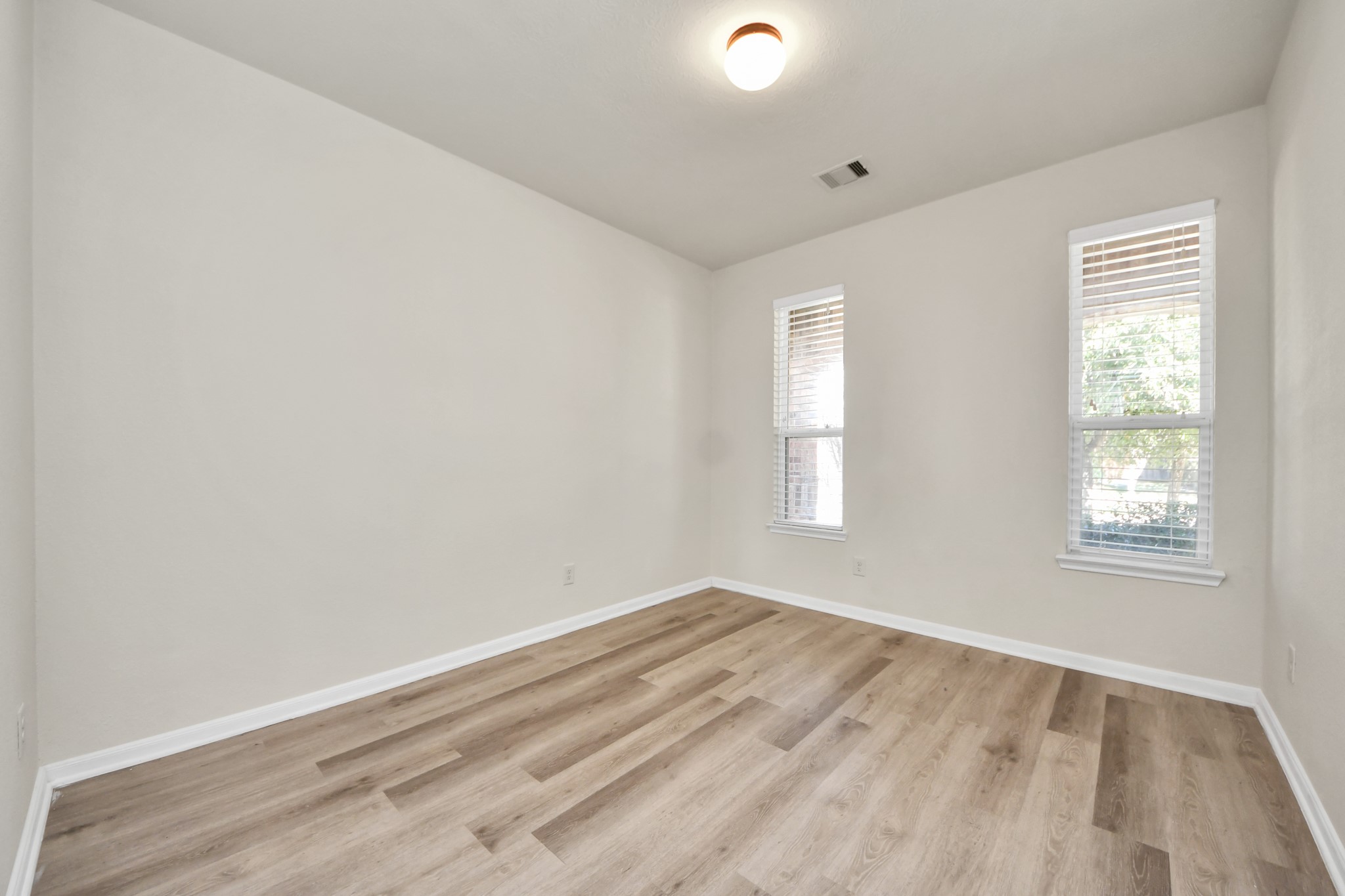 24123 Adobe Ridge Lane Katy, TX 77493 - Photo 8 of 45 an empty room with wooden floor and windows
