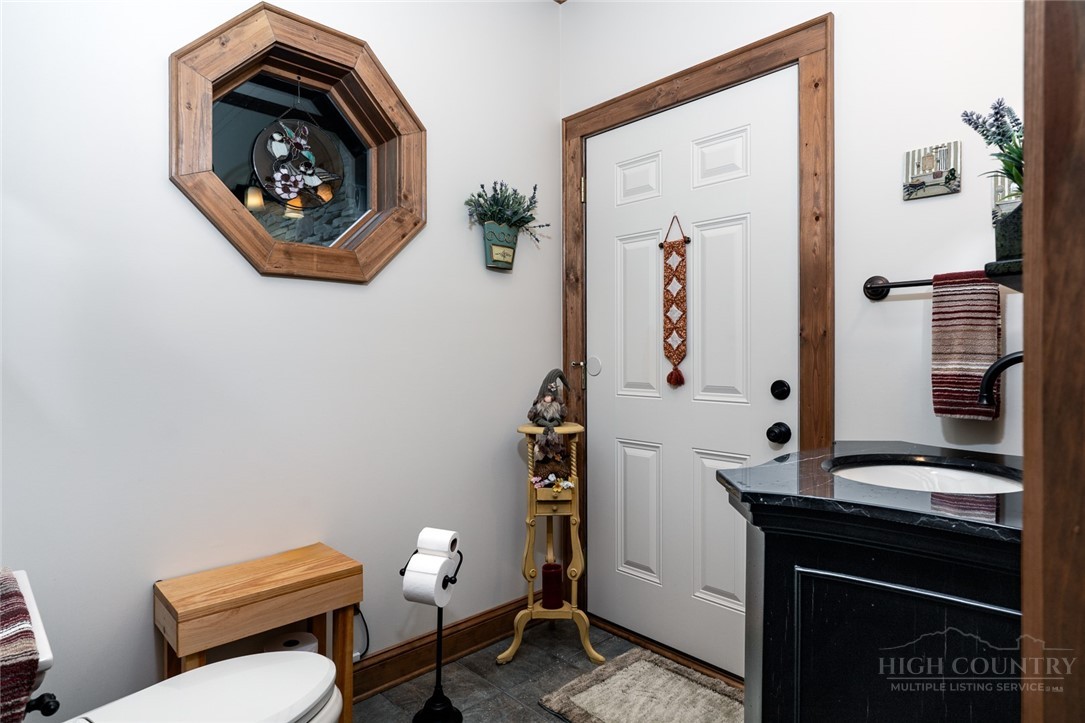 171 Camp Davis Road Banner Elk, NC 28604 - Photo 27 of 48 a bathroom with a toilet a sink and mirror