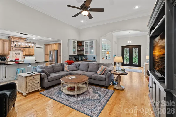 a living room with furniture ceiling fan and a rug