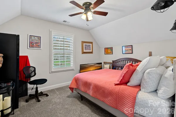 a bedroom with bed and a window