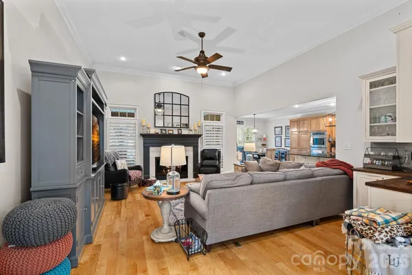 a living room with furniture fireplace and chandelier