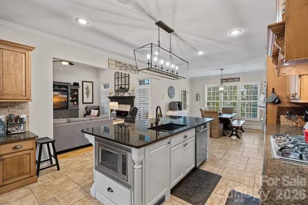 a kitchen with stainless steel appliances granite countertop a stove and cabinets