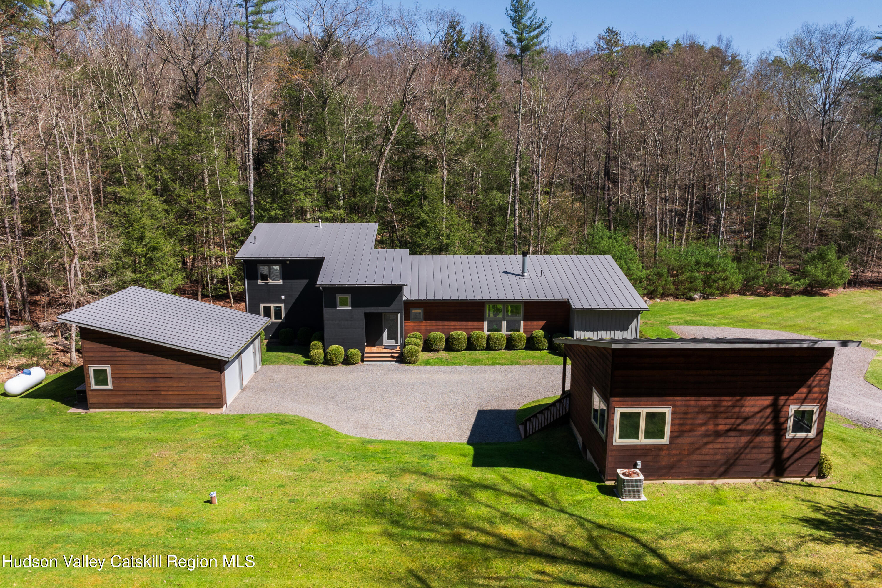 an aerial view of a house with garden and trees