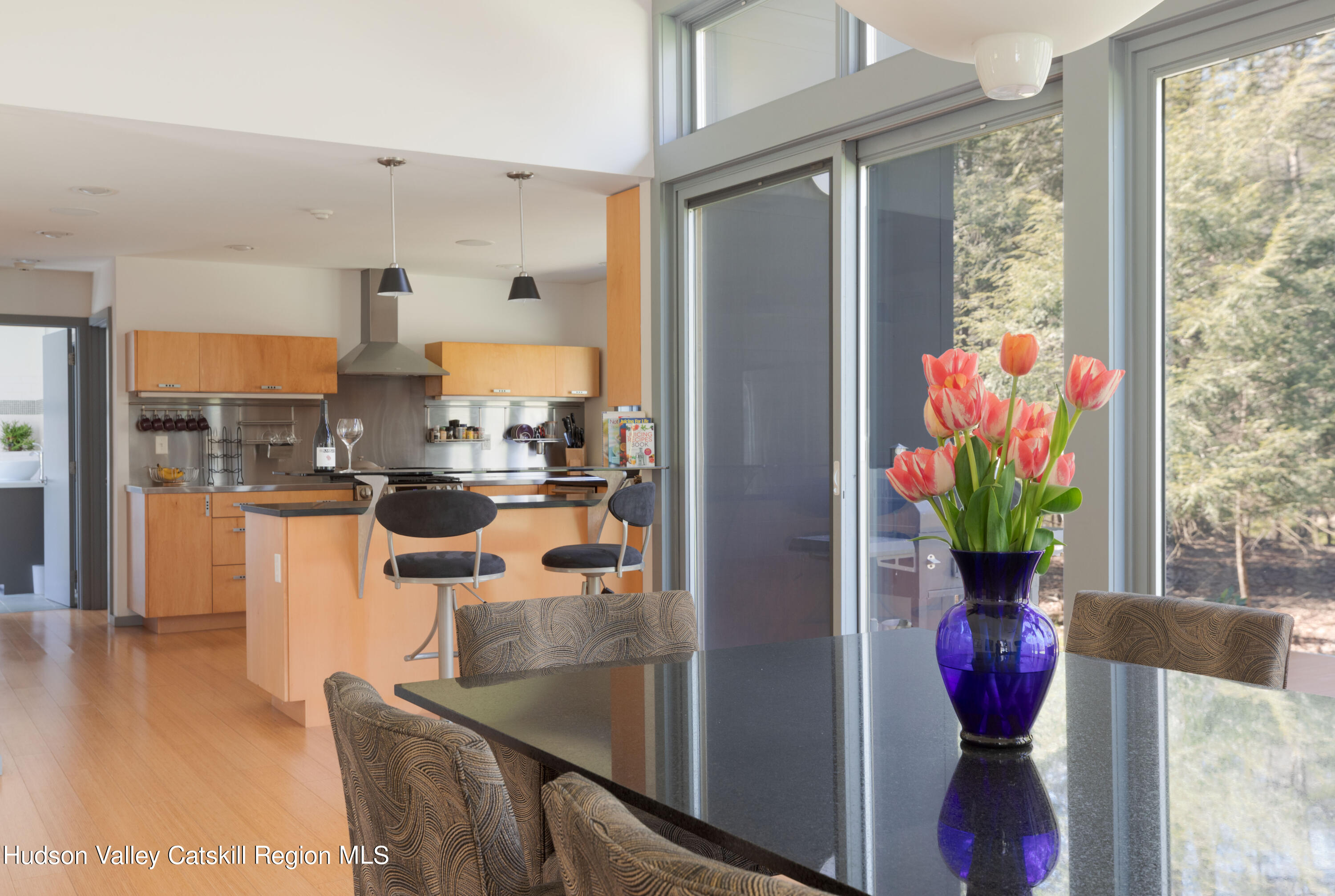 177 Stillwater Road Stone Ridge, NY 12484 - Photo 4 of 27 a dining room with furniture potted plants and wooden floor