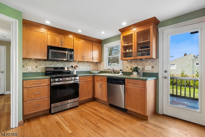 8 Edison Drive Summit, NJ 07901 - Photo 11 of 34 a kitchen with stainless steel appliances granite countertop a stove a sink and a microwave