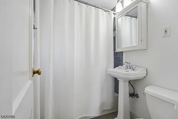 a bathroom with a shower a toilet and a sink
