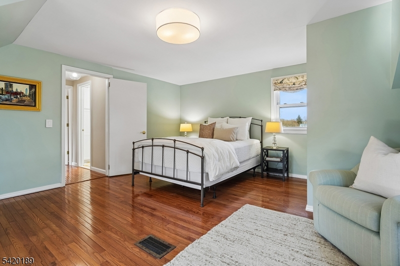 8 Edison Drive Summit, NJ 07901 - Photo 17 of 34 a bedroom with a bed and wooden floor