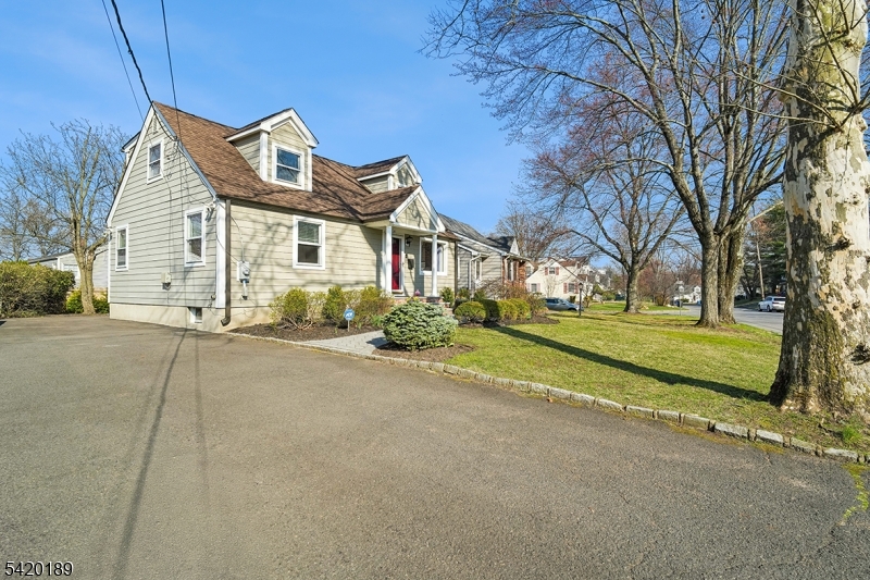 8 Edison Drive Summit, NJ 07901 - Photo 3 of 34 a front view of a house with a garden