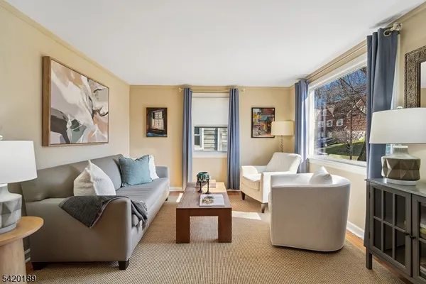 a living room with furniture and a floor to ceiling window