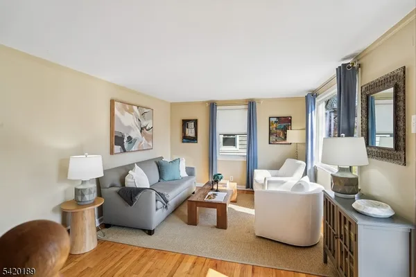 a kitchen with stainless steel appliances granite countertop a refrigerator a sink dishwasher and wooden cabinets with wooden floor