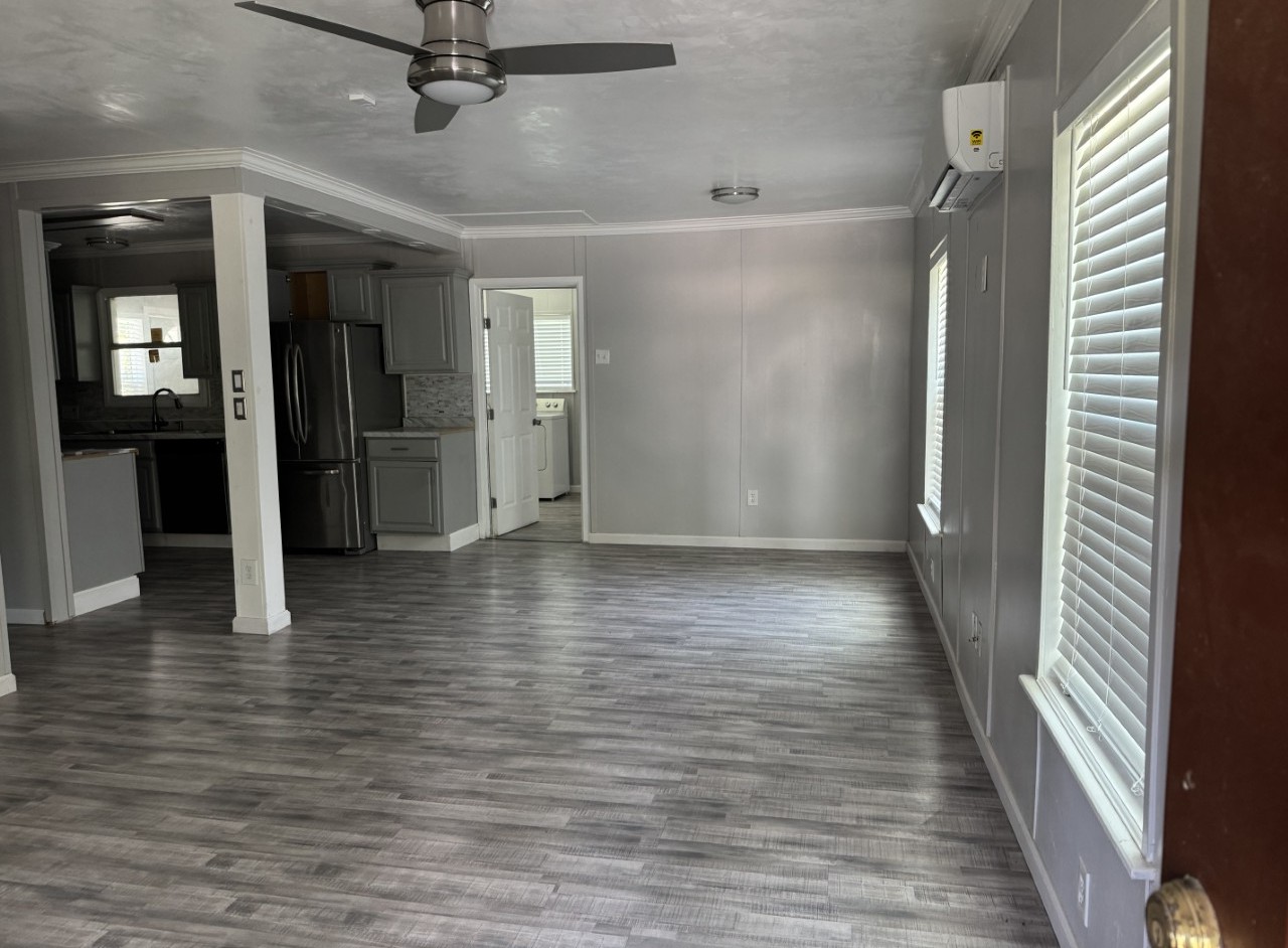 1813 Rhodes Road Austin, TX 78721 - Photo 3 of 14 A spacious living area with resilient flooring flows seamlessly into a well-appointed kitchen.