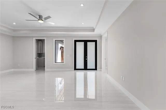 a view of a hallway with wooden floor and a ceiling fan