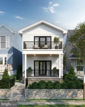 a view of a white house with large windows and a small yard