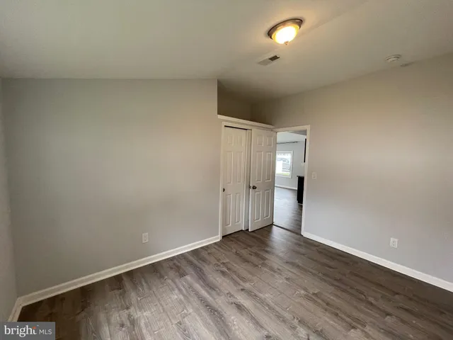 a view of an empty room and wooden floor
