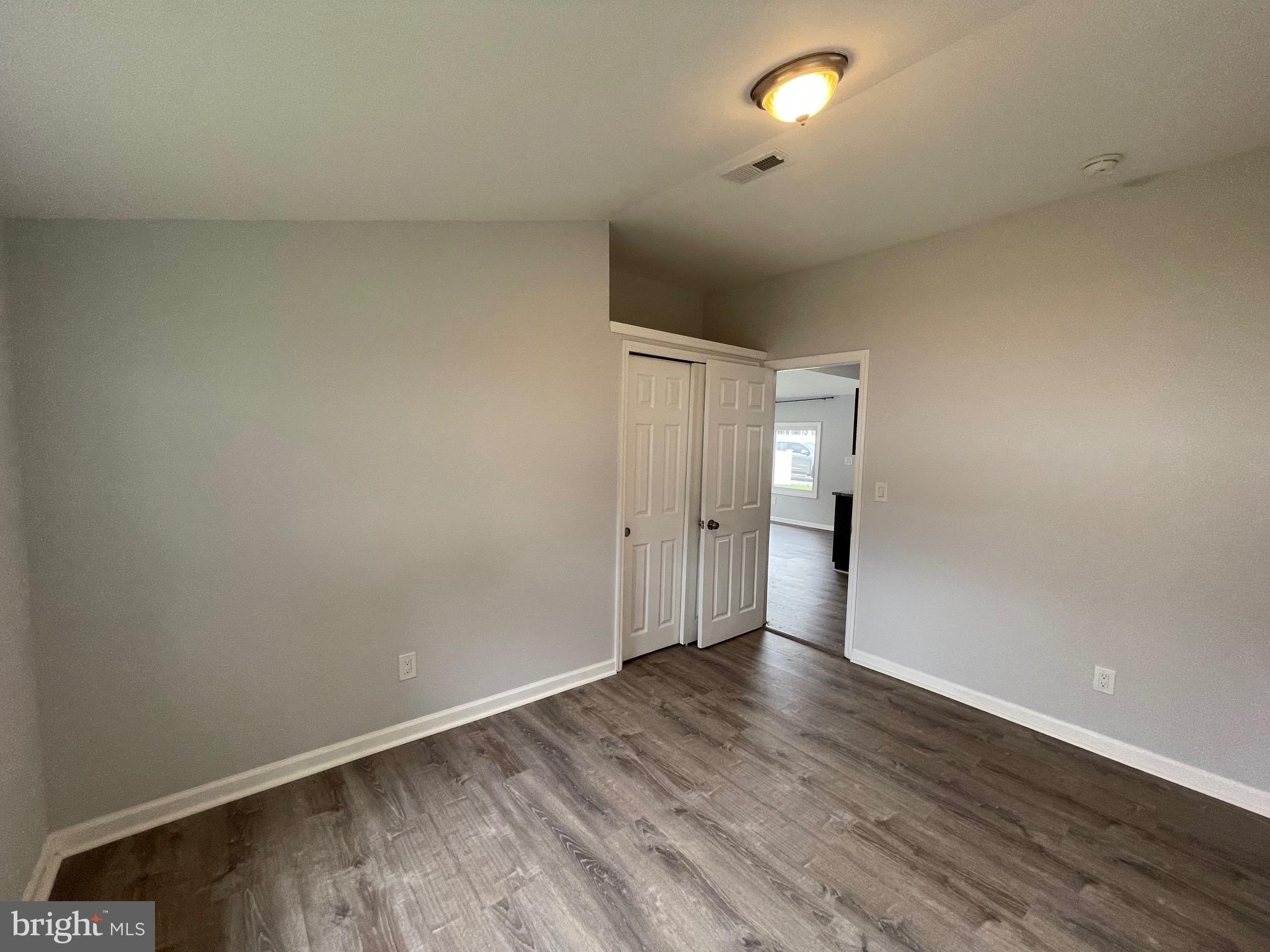 1013 Anchor Way Forked River, NJ 08731 - Photo 6 of 10 a view of an empty room and wooden floor