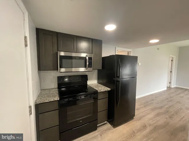 a kitchen with a refrigerator and a microwave