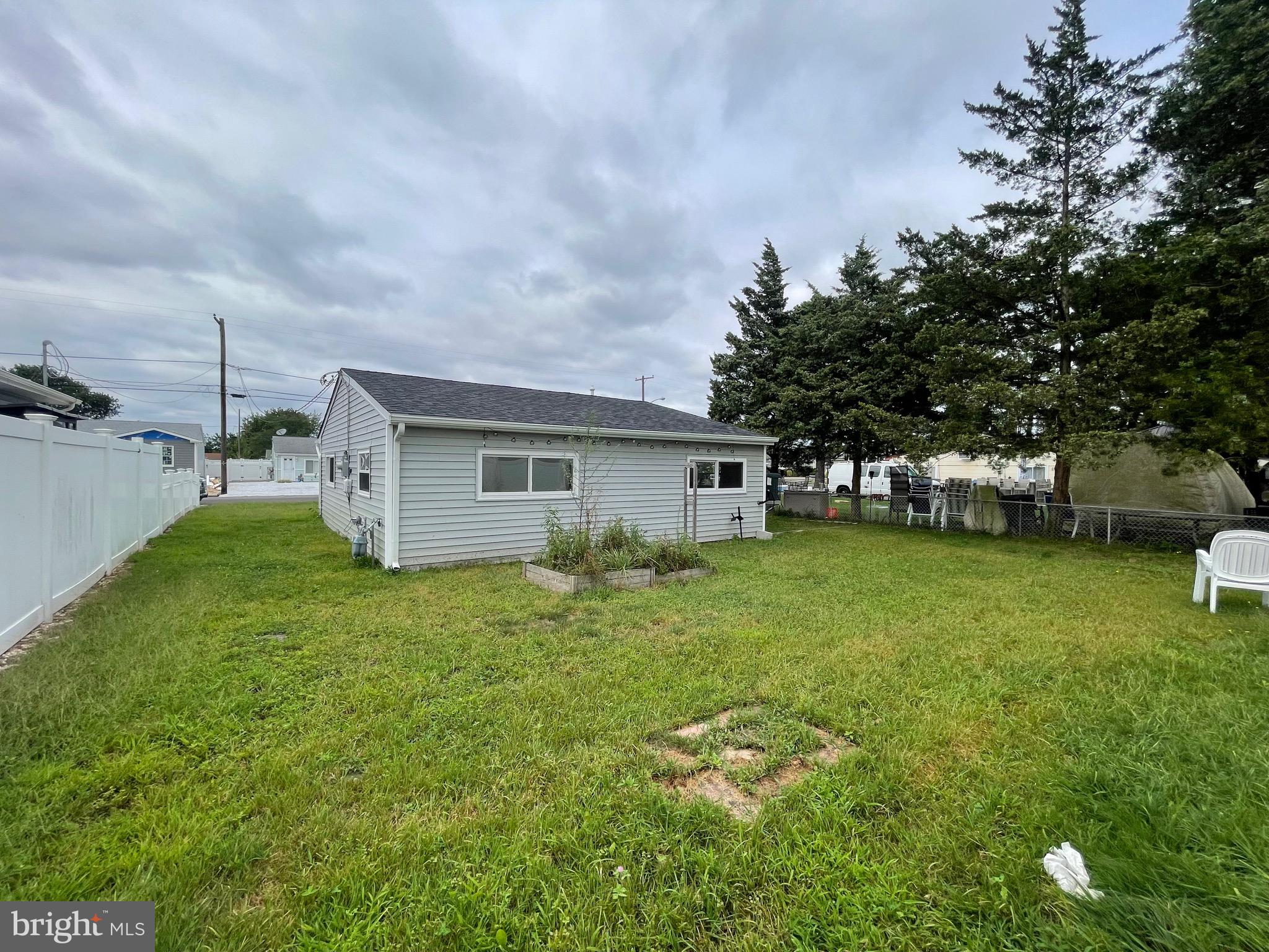 1013 Anchor Way Forked River, NJ 08731 - Photo 10 of 10 a backyard of a house with table and chairs