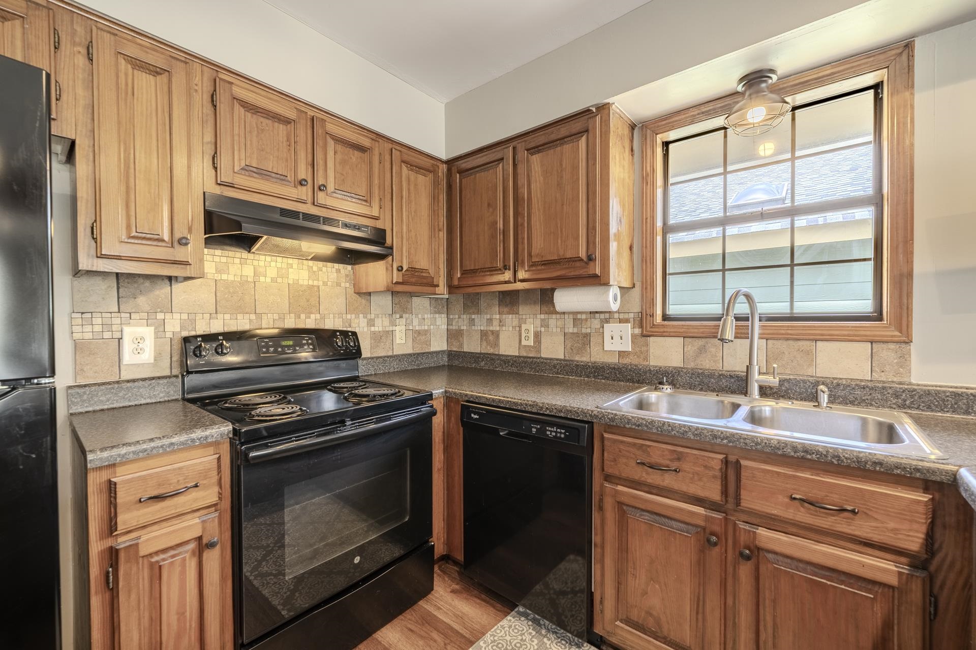 1085 Old Road Counce, TN 38326 - Photo 17 of 30 a kitchen with stainless steel appliances granite countertop a stove sink and cabinets
