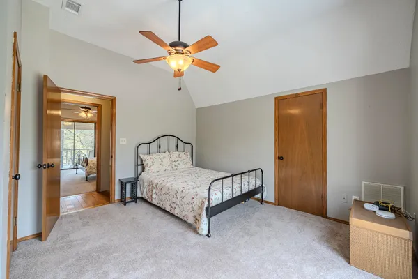 a bedroom with a bed and a chandelier
