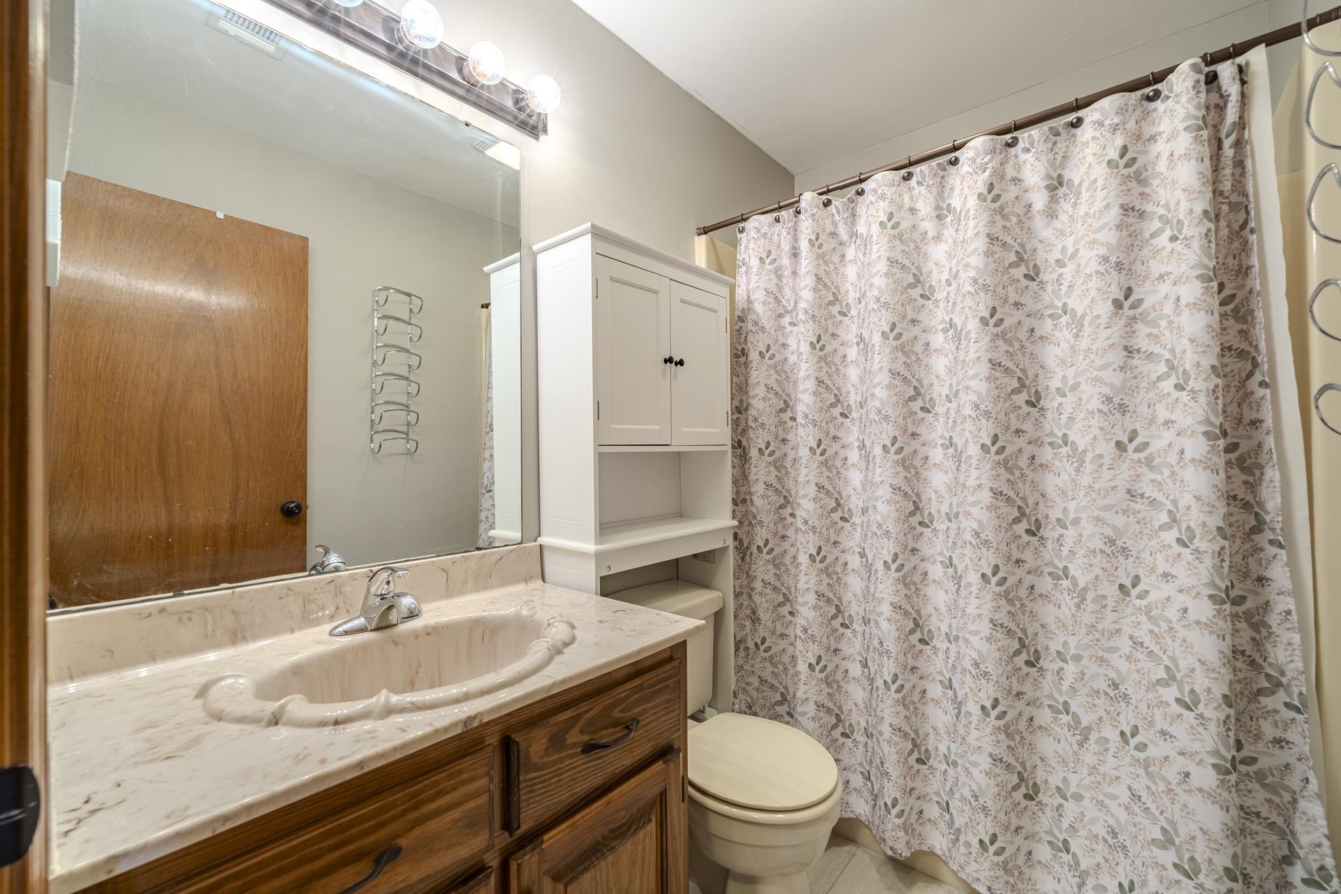 1085 Old Road Counce, TN 38326 - Photo 21 of 30 a bathroom with a granite countertop sink and a mirror