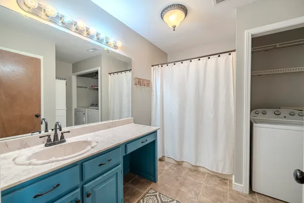 a bathroom with a double vanity sink and a mirror