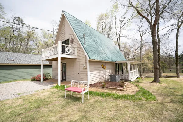 a backyard of a house with yard and outdoor seating