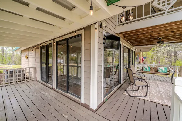 a view of a porch with wooden floor front door