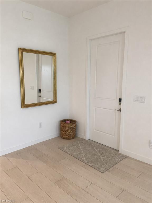 14866 Loggerhead Drive Naples, FL 34120 - Photo 3 of 16 a bedroom with a bed and a painting on the wall