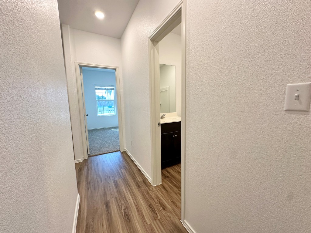 13410 Mussel Run Elgin, TX 78621 - Photo 9 of 32 a view of hallway with wooden floor