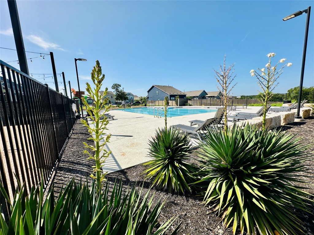 13410 Mussel Run Elgin, TX 78621 - Photo 27 of 32 a swimming pool with outdoor seating and plants