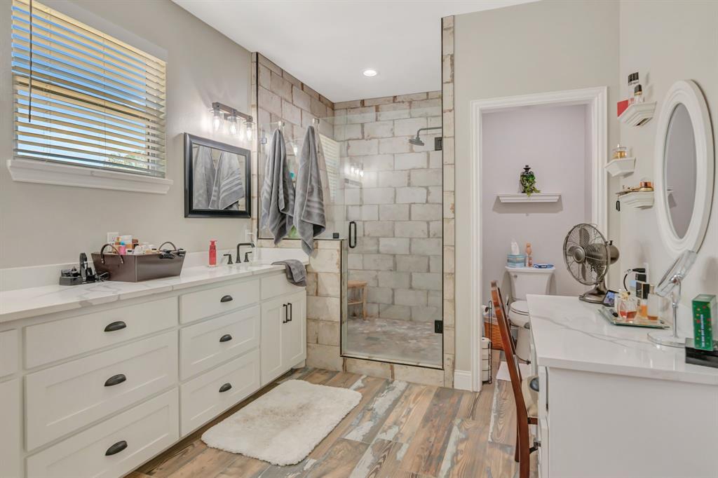 129 Whiskey Rnch Road Runaway Bay, TX 76426 - Photo 23 of 39 a bathroom with a shower sink and mirror