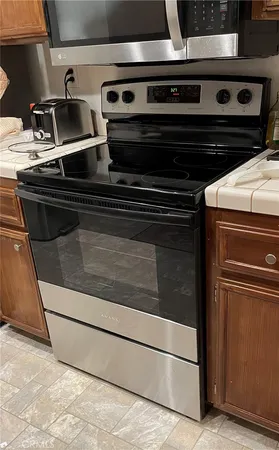 a stove top oven sitting inside of a kitchen