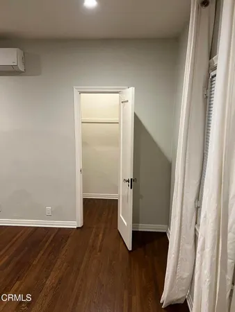 an empty room with wooden floor and door