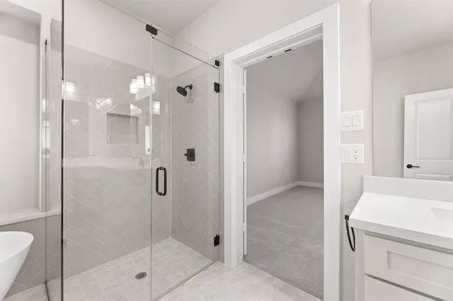a bathroom with a shower and a sink