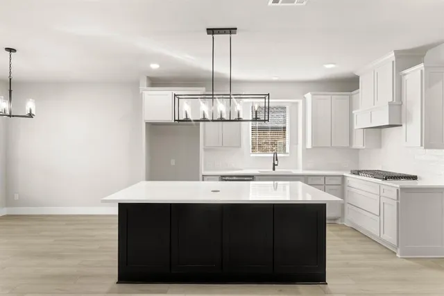 a kitchen with a sink cabinets and window