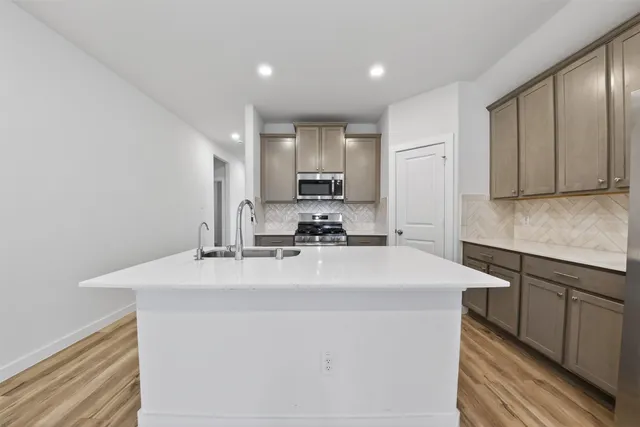 a kitchen with a sink a stove and refrigerator