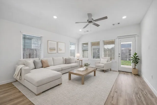 a living room with furniture and a large window