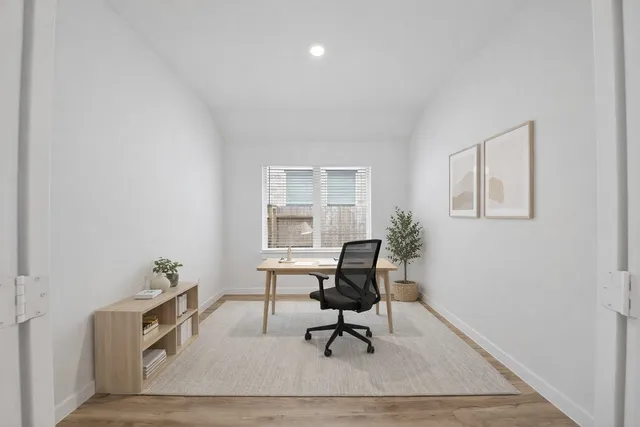 a workspace room with furniture and a potted plant