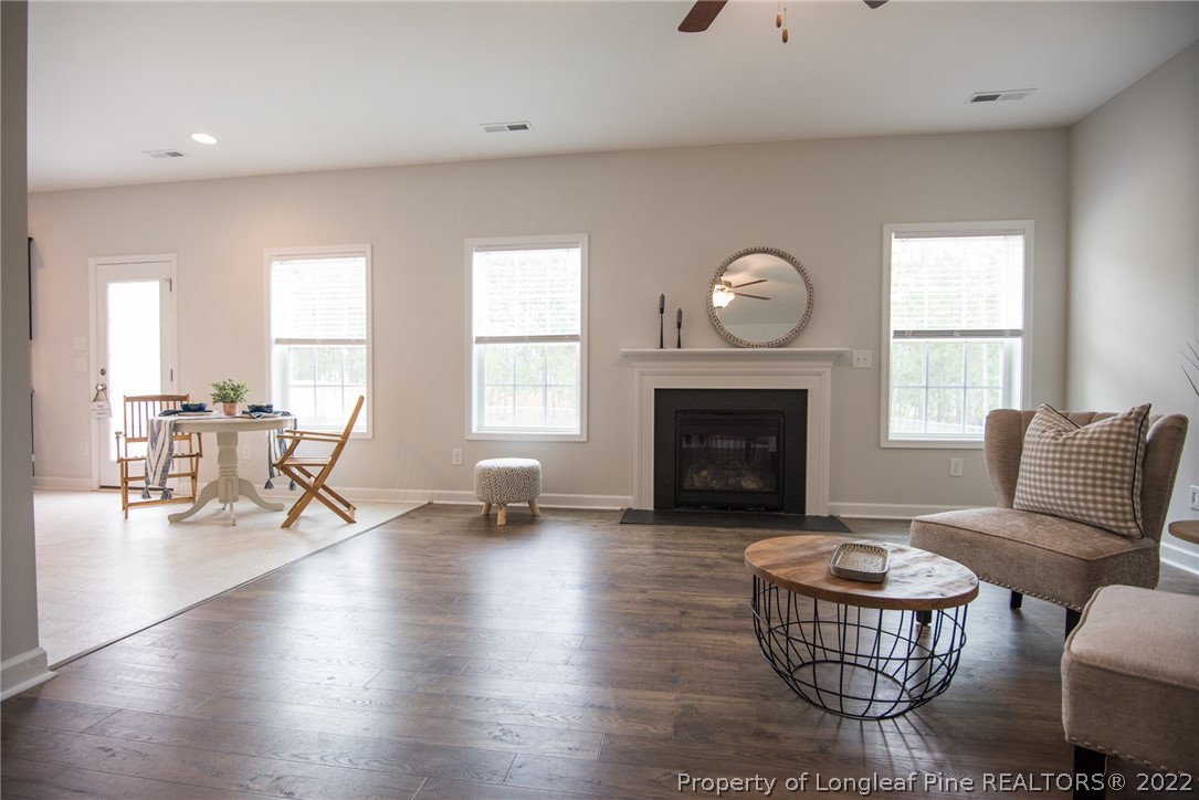 4095 Irwin Drive Aberdeen, NC 28315 - Photo 25 of 50 a living room with furniture a fireplace and a large window