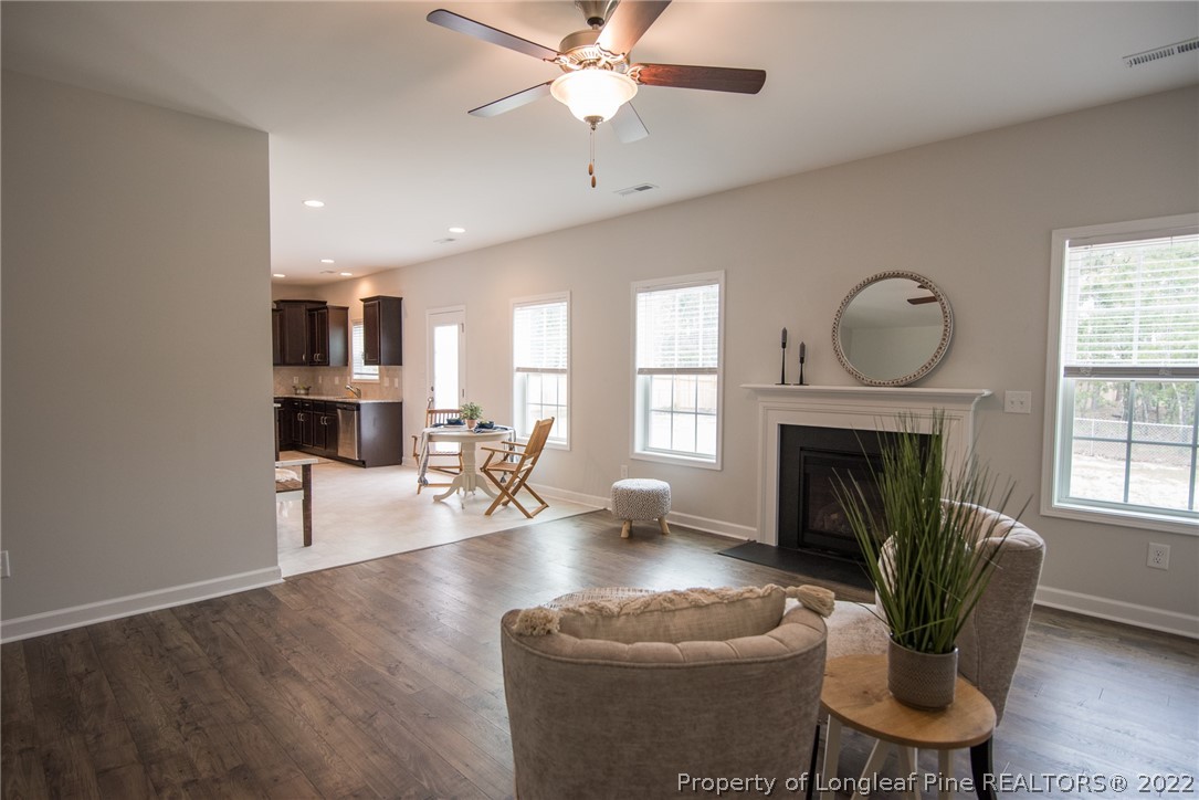 4095 Irwin Drive Aberdeen, NC 28315 - Photo 26 of 50 a living room with furniture a fireplace and a chandelier