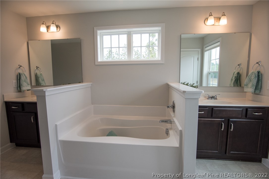 4095 Irwin Drive Aberdeen, NC 28315 - Photo 33 of 50 a bathroom with a bathtub a sink and a window
