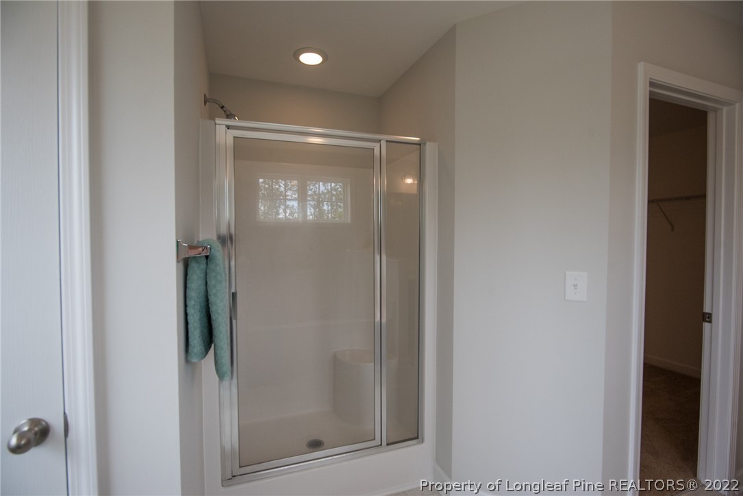4095 Irwin Drive Aberdeen, NC 28315 - Photo 35 of 50 a bathroom with a glass shower door