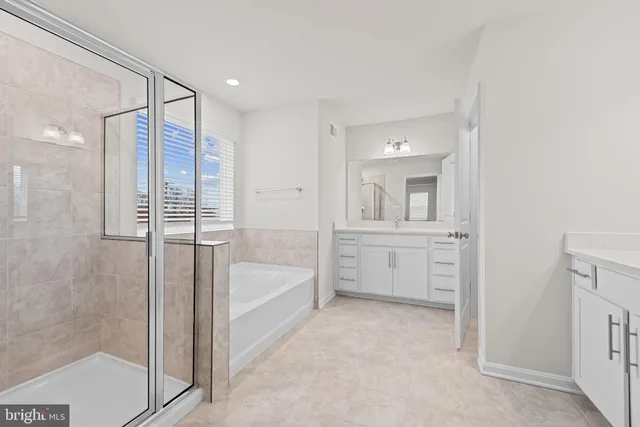 a bathroom with a tub shower and sink