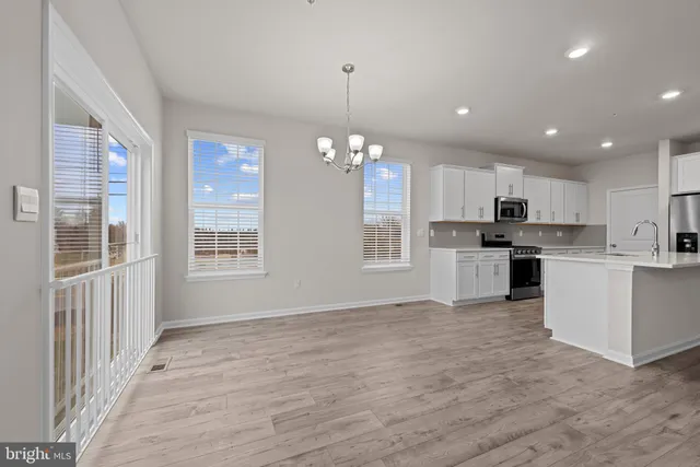 a view of a kitchen with microwave and cabinets