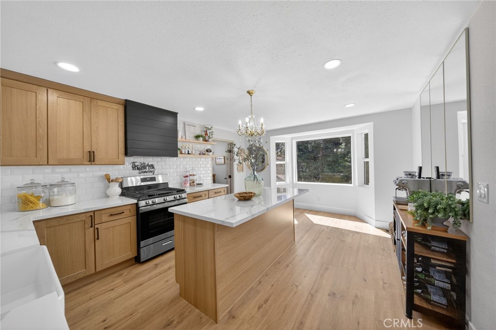 1171 Bear Springs Road Rimforest, CA 92378 - Photo 12 of 43 a kitchen with stainless steel appliances granite countertop a sink stove and refrigerator
