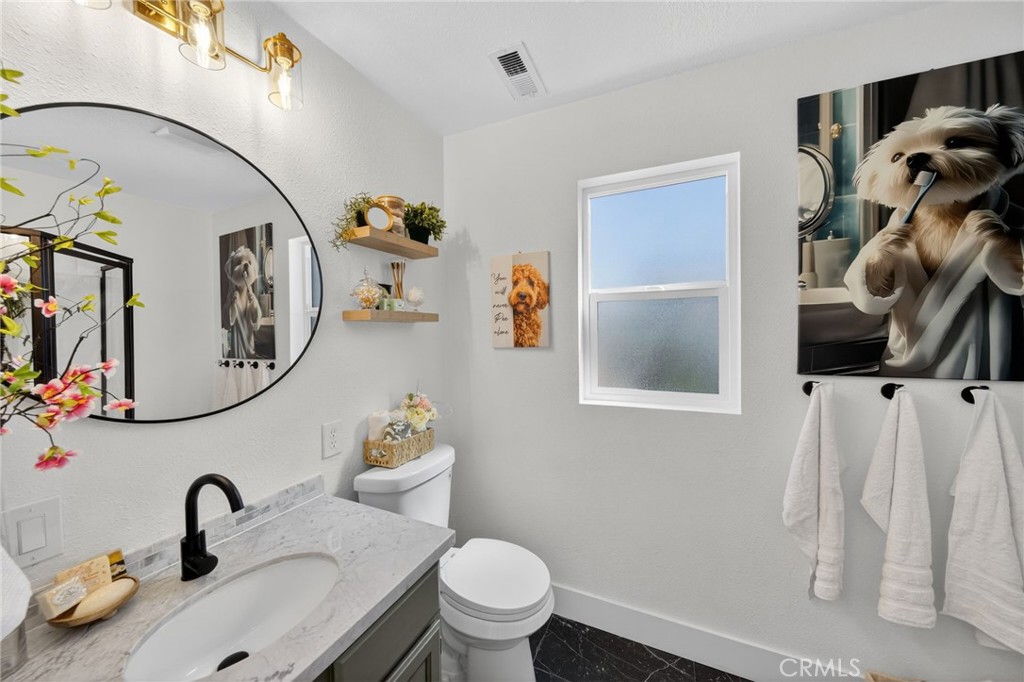 1171 Bear Springs Road Rimforest, CA 92378 - Photo 15 of 43 a bathroom with a toilet sink and mirror