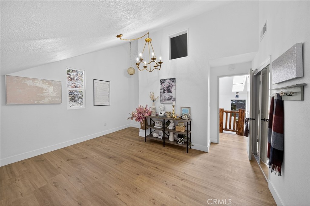 1171 Bear Springs Road Rimforest, CA 92378 - Photo 25 of 43 a view of a livingroom with furniture and a flat screen tv